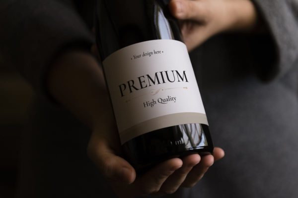 手持葡萄酒瓶标签设计样机 Wine Bottle Mockup